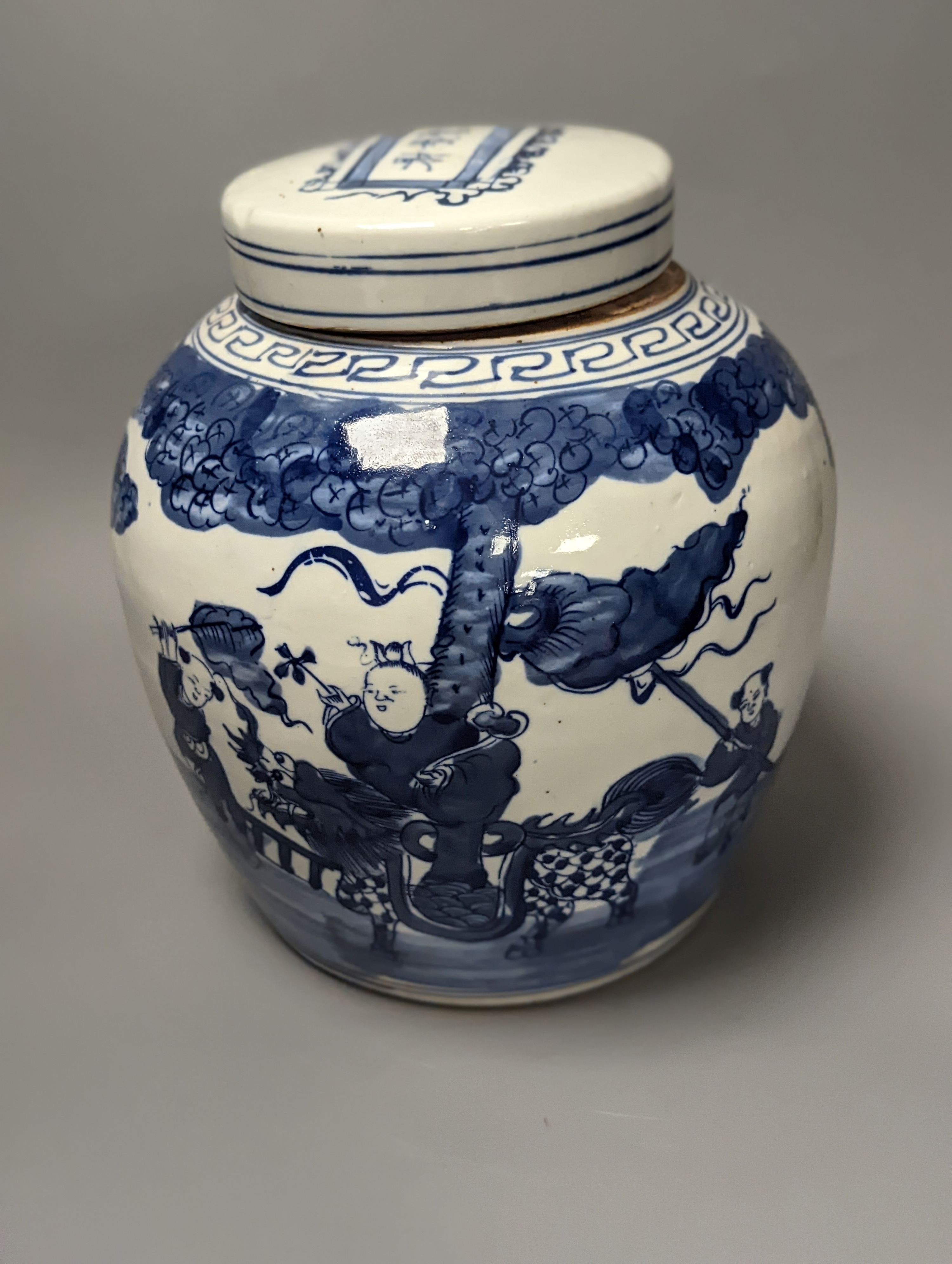 A Chinese blue and white jar and cover, 25 cm high and a celadon glazed lamp